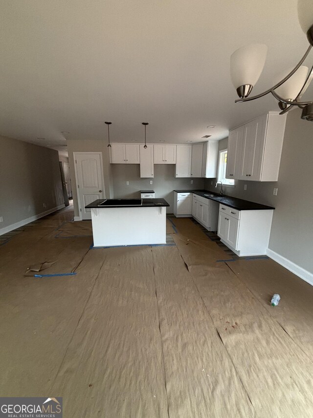 kitchen with white cabinetry, a center island, stainless steel appliances, and light hardwood / wood-style flooring