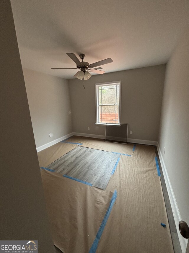 empty room featuring light wood-type flooring and ceiling fan