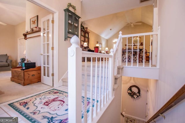 interior space with carpet floors, ceiling fan, and lofted ceiling