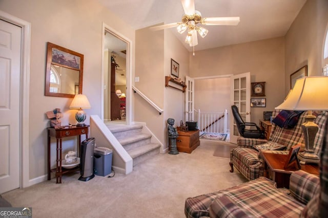 sitting room with ceiling fan, carpet floors, and french doors