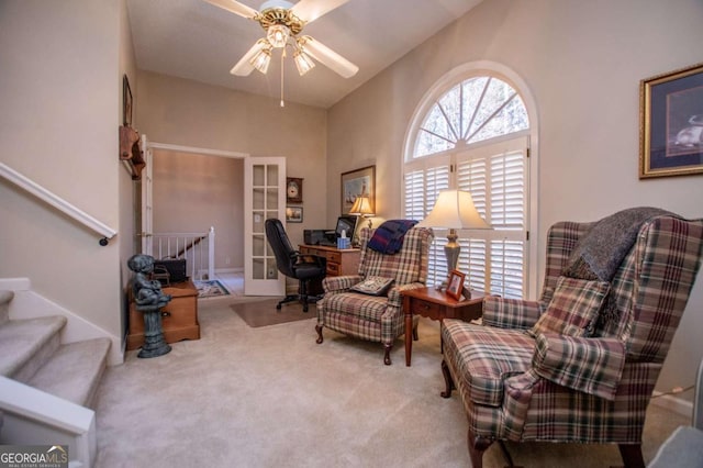 living area featuring ceiling fan, french doors, and carpet