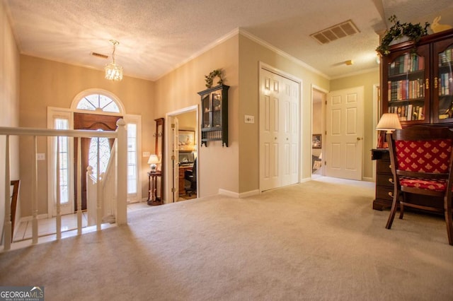 living area featuring carpet flooring, a textured ceiling, and ornamental molding