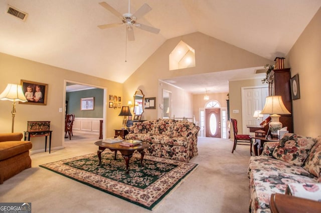 living room with light colored carpet, high vaulted ceiling, and ceiling fan