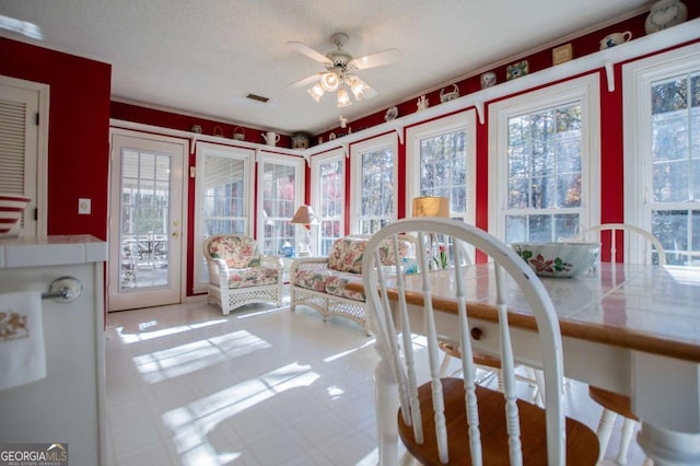 interior space with ceiling fan