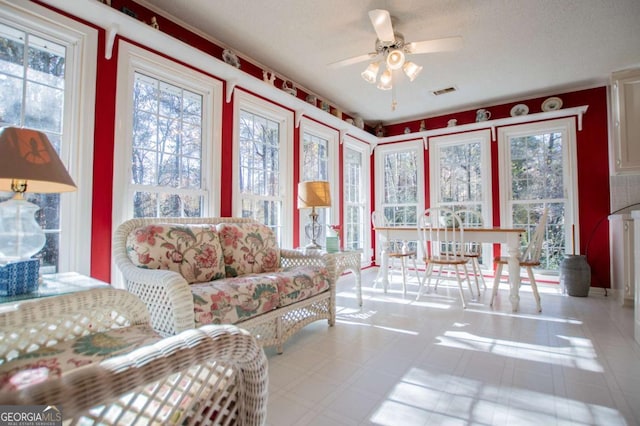 sunroom with ceiling fan and a healthy amount of sunlight