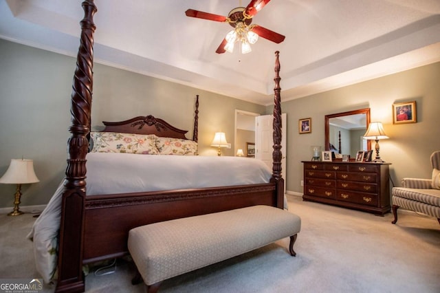 bedroom with light colored carpet, a raised ceiling, ceiling fan, and crown molding