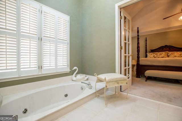 bathroom with tile patterned flooring, ceiling fan, and a tub