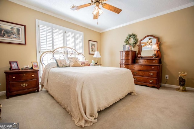 carpeted bedroom featuring ceiling fan and ornamental molding