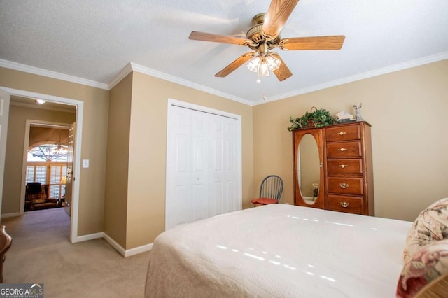 bedroom featuring light carpet, a closet, ceiling fan, and crown molding