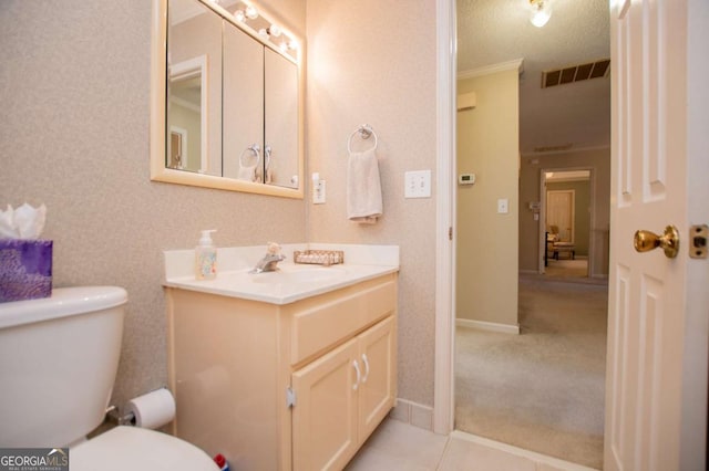 bathroom with vanity, a textured ceiling, toilet, and ornamental molding