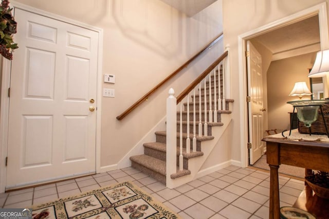 entryway with light tile patterned floors