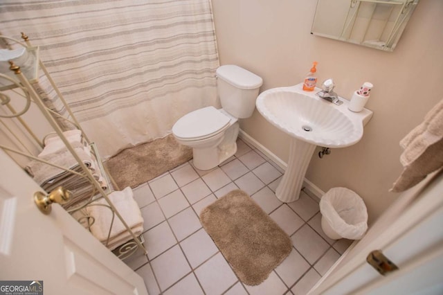 bathroom with tile patterned floors, toilet, and sink