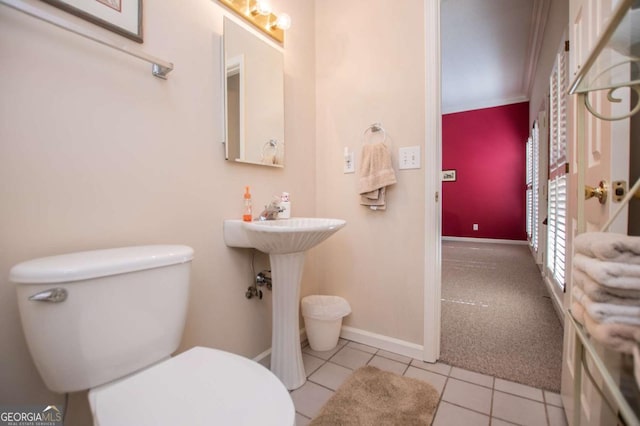 bathroom featuring tile patterned floors, toilet, and ornamental molding