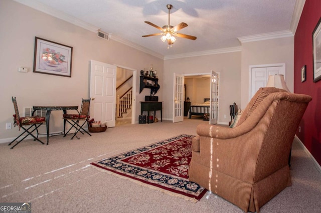 carpeted living room featuring ceiling fan, crown molding, and french doors