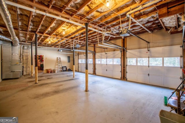 garage featuring a garage door opener and heating unit