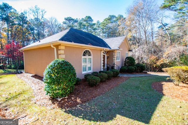 view of home's exterior with a lawn