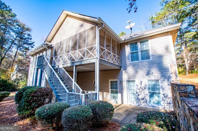 rear view of property with a sunroom