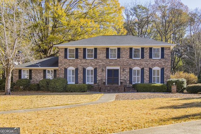 colonial-style house with a front yard