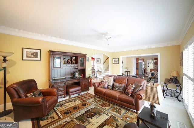 living room featuring ceiling fan and crown molding