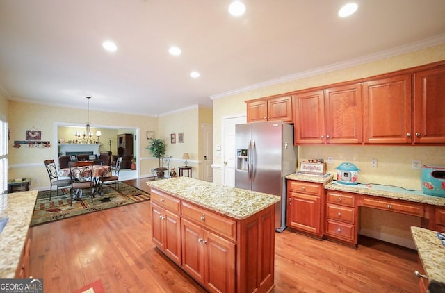 kitchen with stainless steel fridge with ice dispenser, light hardwood / wood-style flooring, pendant lighting, and ornamental molding