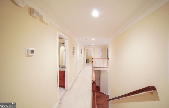 corridor featuring crown molding and light hardwood / wood-style flooring