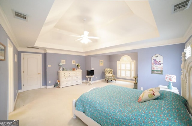 carpeted bedroom featuring a raised ceiling, ceiling fan, and ornamental molding