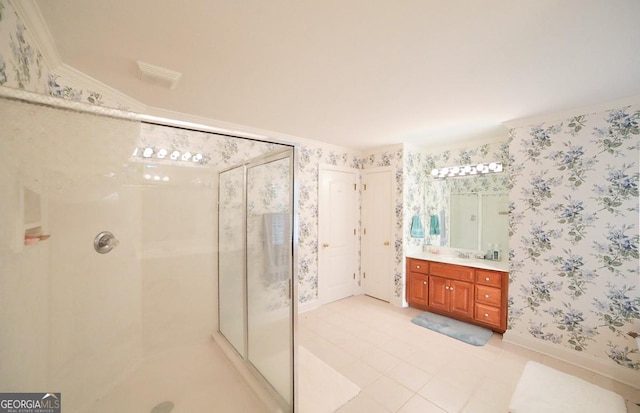 bathroom featuring crown molding, vanity, and a shower with shower door