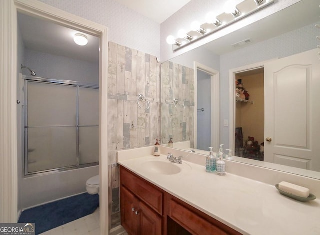 full bathroom with shower / bath combination with glass door, vanity, and toilet