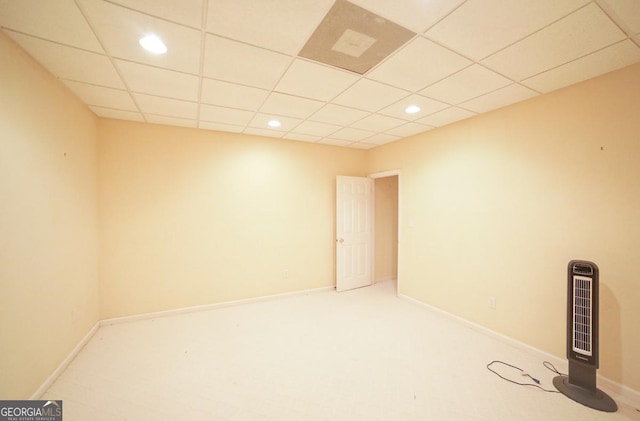 spare room with a paneled ceiling and heating unit