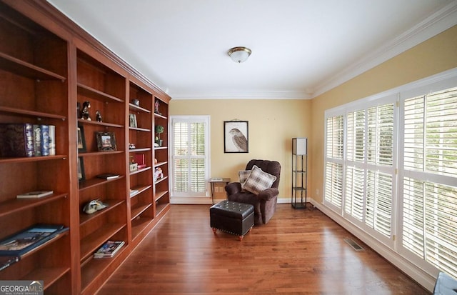 sitting room featuring crown molding and wood-type flooring