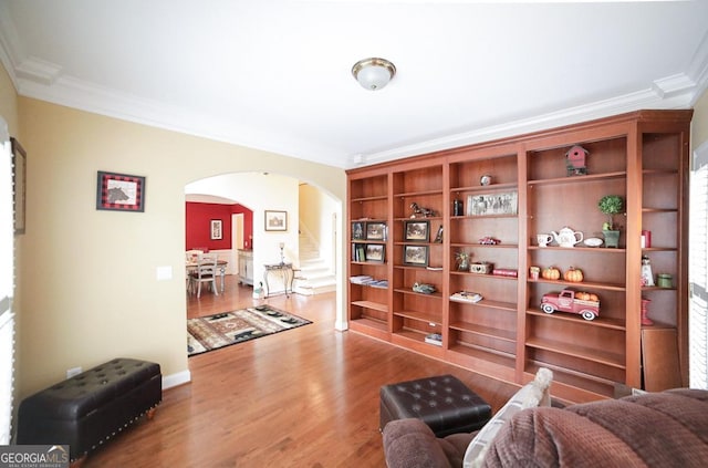 sitting room featuring wood-type flooring and ornamental molding