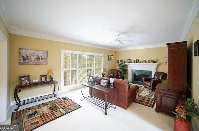 carpeted living room with ceiling fan and crown molding