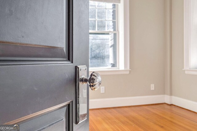 laundry area featuring hardwood / wood-style flooring