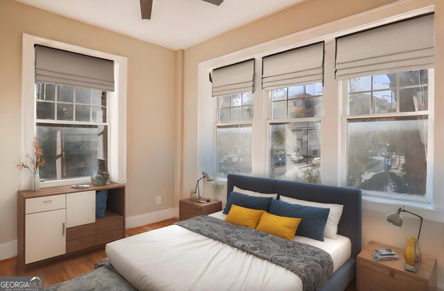 bedroom featuring hardwood / wood-style floors and ceiling fan