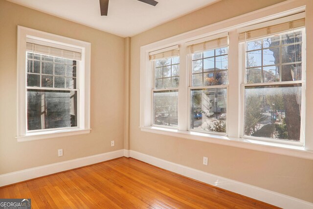 spare room with wood-type flooring and ceiling fan