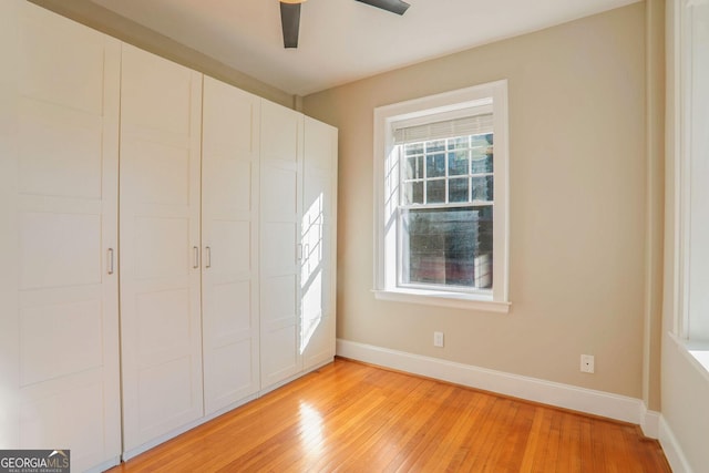 unfurnished bedroom featuring a closet, ceiling fan, and light hardwood / wood-style flooring