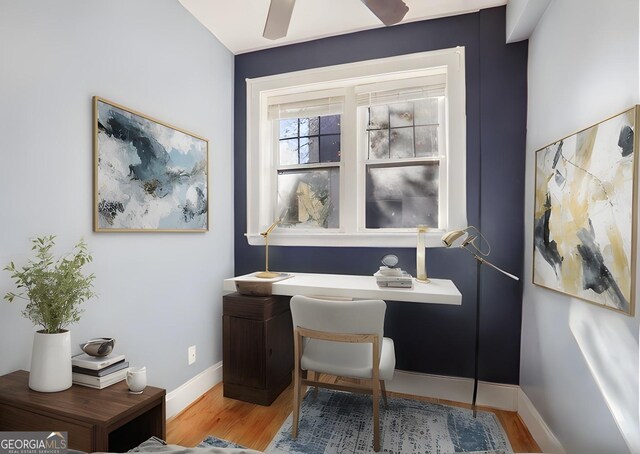 office space with wood-type flooring and ceiling fan