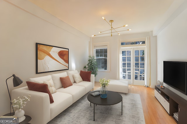 living room featuring an inviting chandelier and light hardwood / wood-style floors