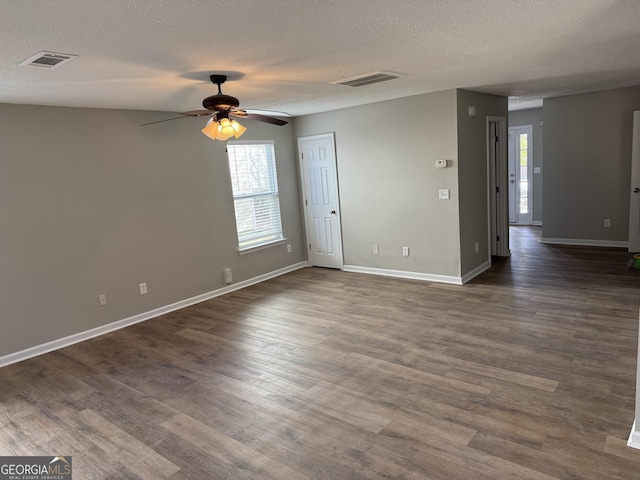 unfurnished room featuring ceiling fan, dark hardwood / wood-style flooring, and a textured ceiling