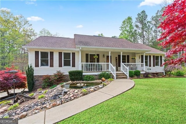 ranch-style house with a porch and a front lawn