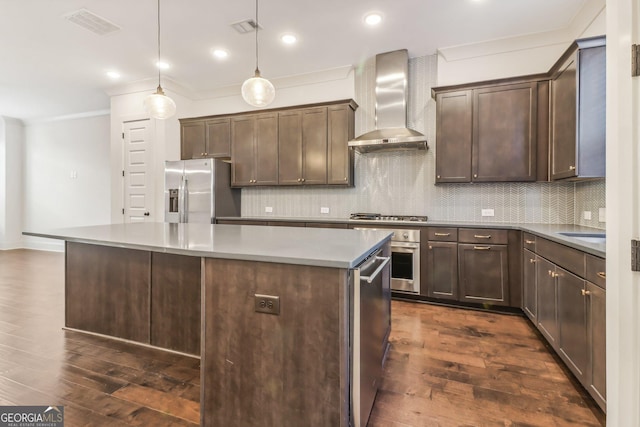 kitchen with ceiling fan, a center island, dark wood-type flooring, stainless steel appliances, and pendant lighting