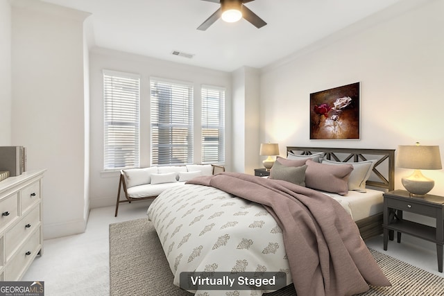 unfurnished bedroom featuring ceiling fan, crown molding, and light colored carpet