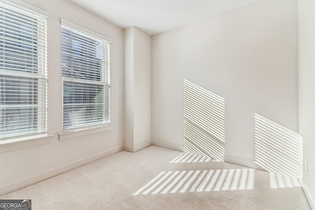 unfurnished room with light carpet