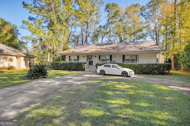 ranch-style home with a porch and a front yard