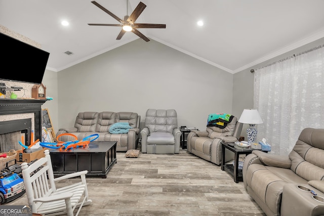 living room featuring crown molding, ceiling fan, lofted ceiling, and light wood-type flooring