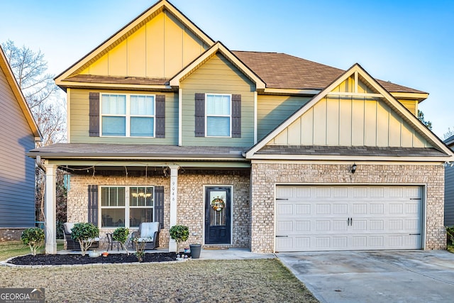 craftsman inspired home featuring covered porch and a garage