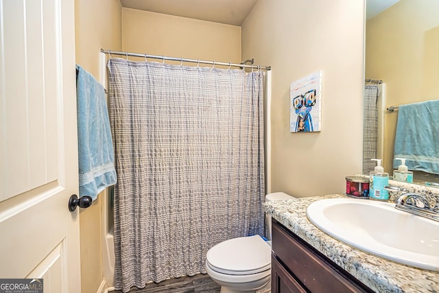 full bathroom with vanity, wood-type flooring, shower / tub combo, and toilet