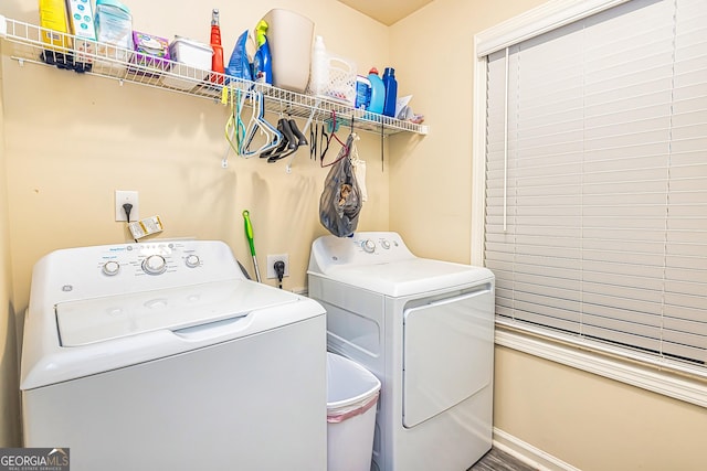 clothes washing area featuring hardwood / wood-style flooring and independent washer and dryer