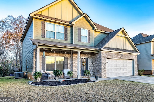 view of front of house with a garage and central AC unit