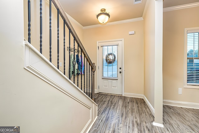 foyer entrance featuring wood-type flooring and crown molding